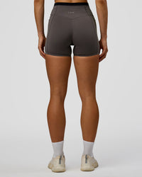 Woman wearing Liberate High-Rise 4" Short Pockets in Duskstone-Black | Model:Maja | Size:XS | Thumbnail Index: 2