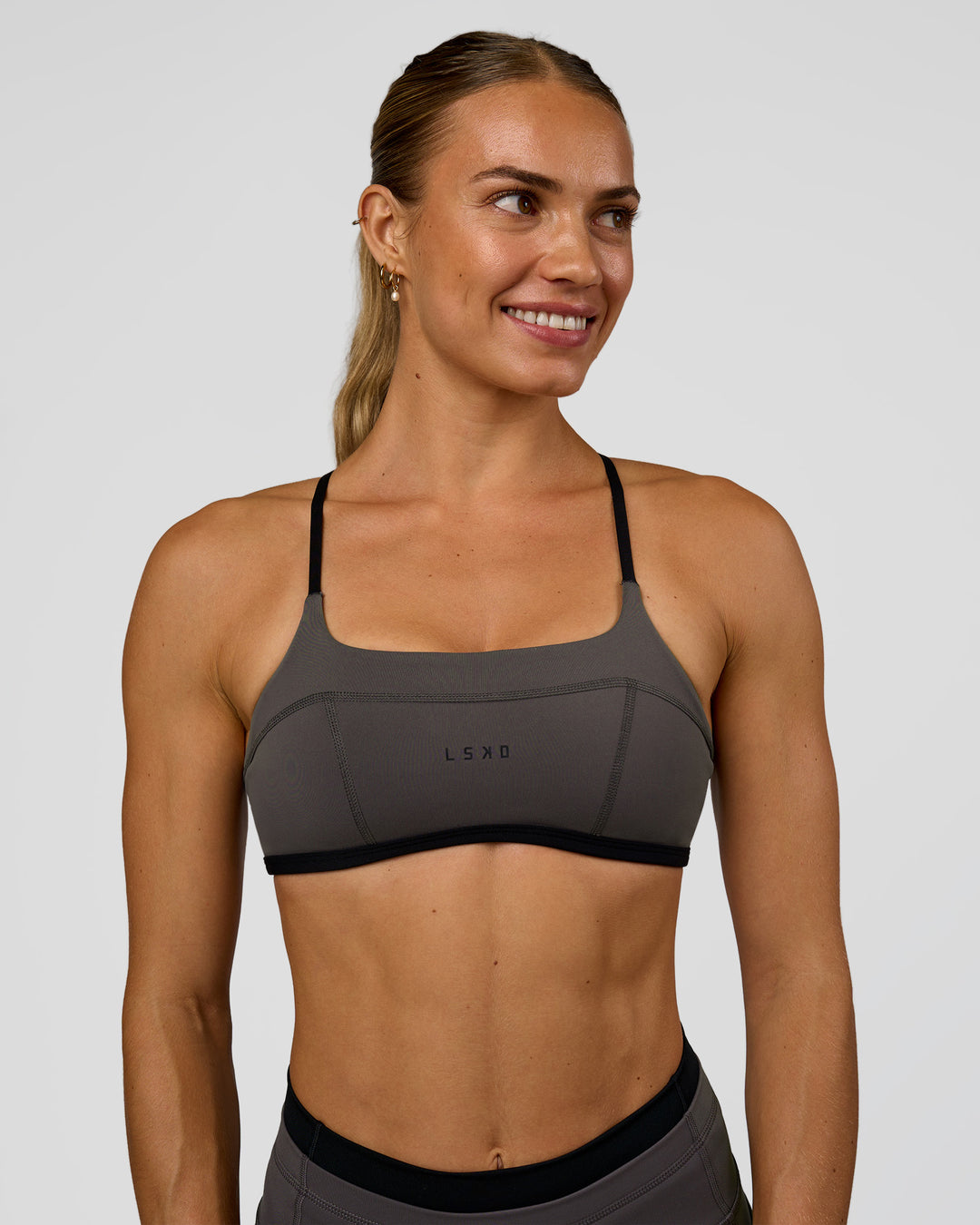 Woman wearing Liberate Sports Bra in Duskstone-Black | Model:Maja | Size:XS - view 1