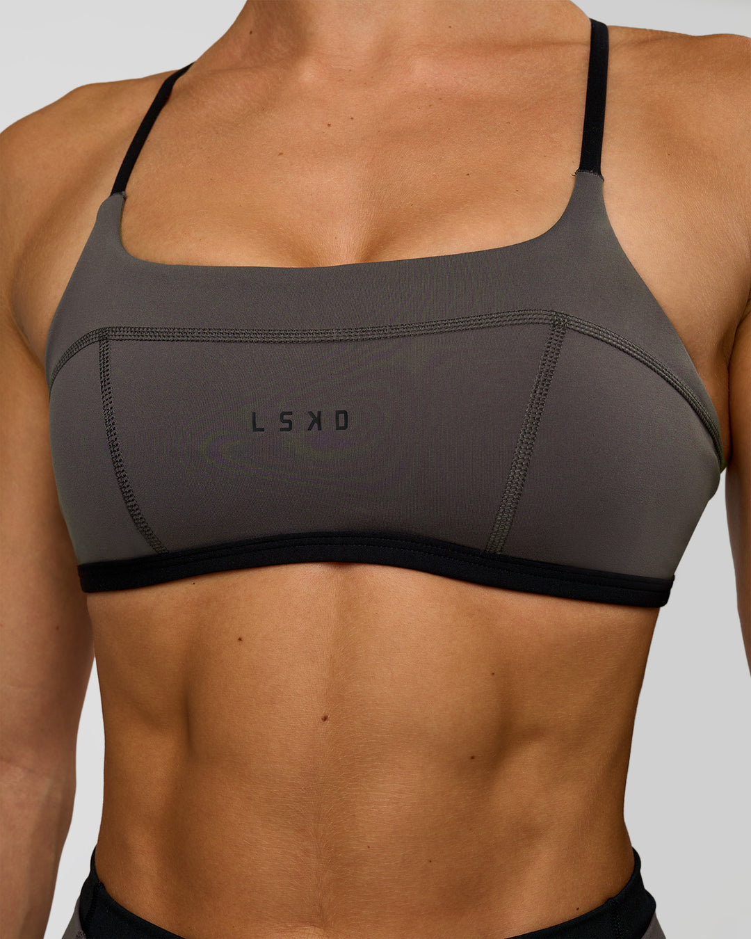 Woman wearing Liberate Sports Bra in Duskstone-Black | Model:Maja | Size:XS - view 3