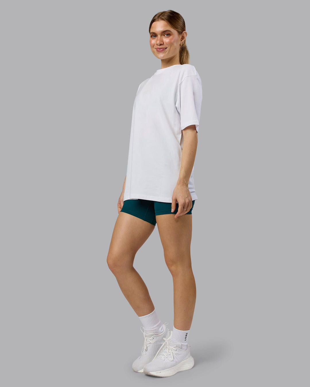 Woman wearing Love The Run FLXCotton Tee Oversize - White-Dark Moss | Model:Emilie | Size:XS - view 10