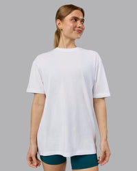 Woman wearing Love The Run FLXCotton Tee Oversize - White-Dark Moss | Model:Emilie | Size:XS | Thumbnail Index: 3