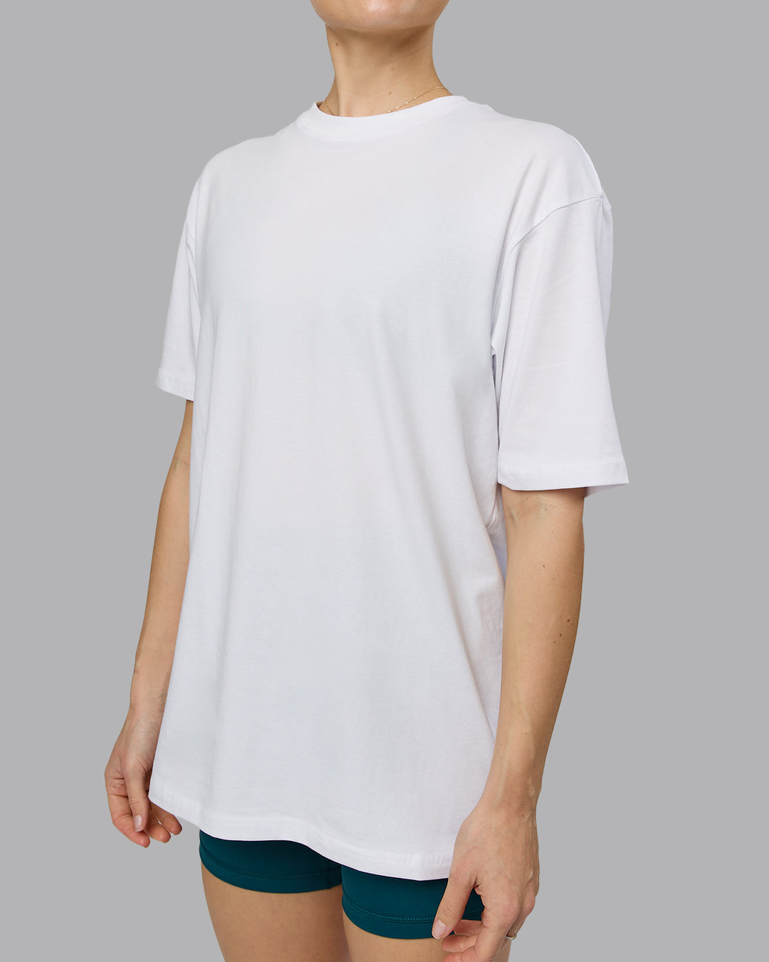 Woman wearing Love The Run FLXCotton Tee Oversize - White-Dark Moss | Model:Emilie | Size:XS - view 11
