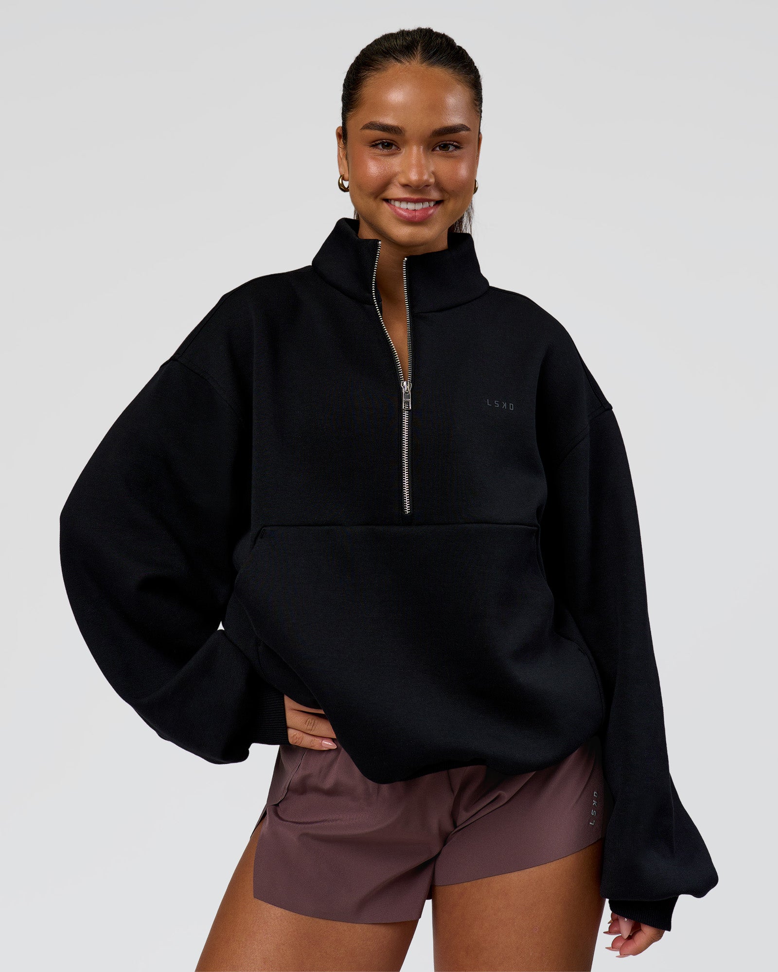 Woman wearing Luxe ZeroCrease Spacer Half Zip - Black | Model:Sophia | Size:XS