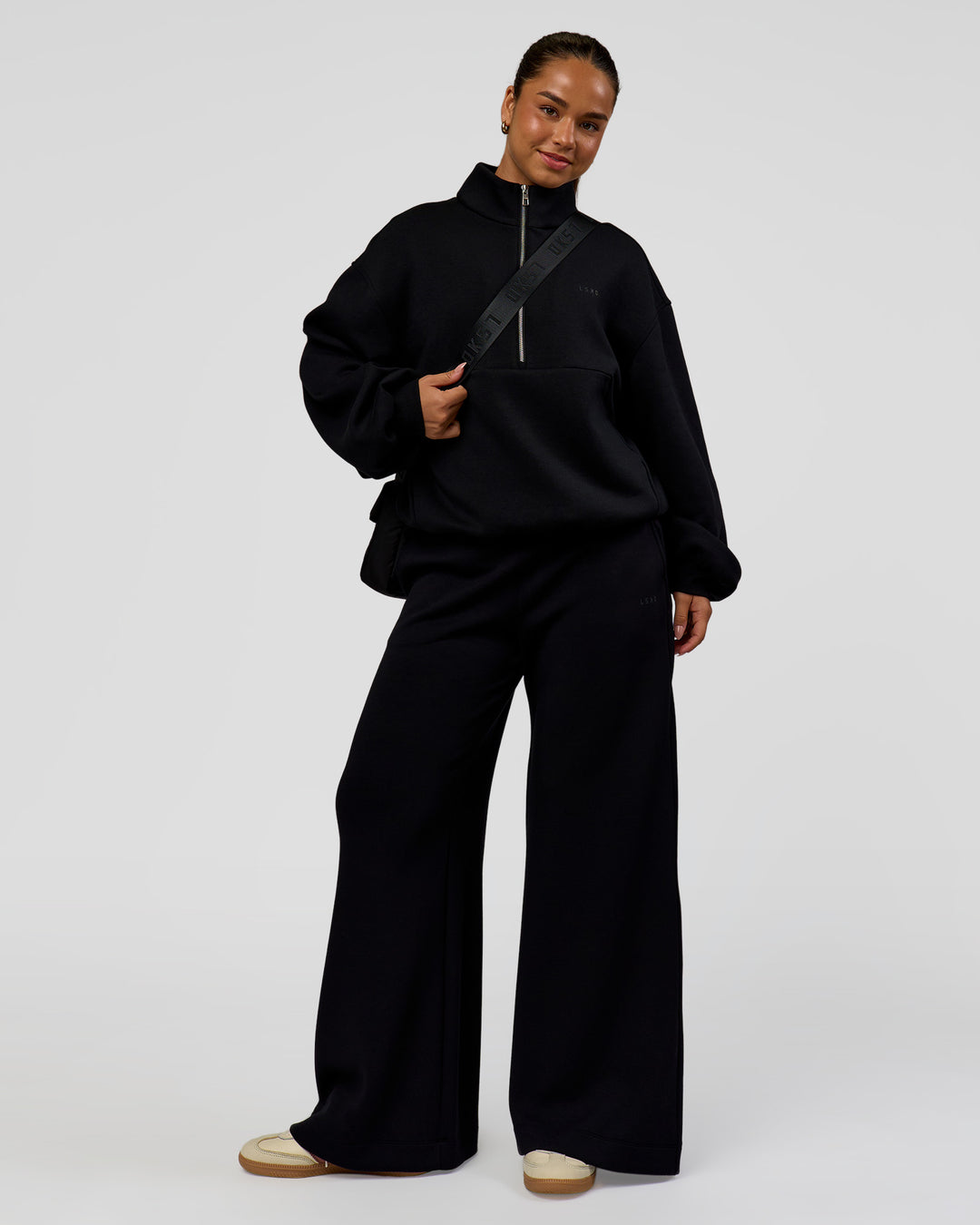 Woman wearing Luxe ZeroCrease Spacer Half Zip - Black | Model:Sophia | Size:XS - view 2