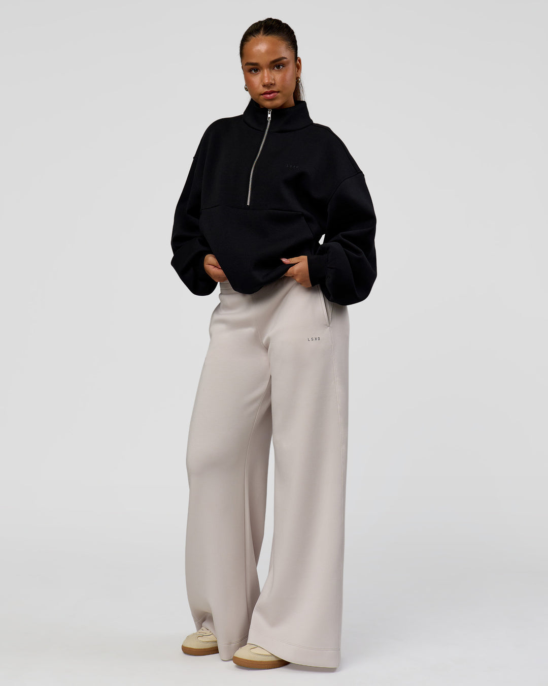 Woman wearing Luxe ZeroCrease Spacer Half Zip - Black | Model:Sophia | Size:XS - view 4