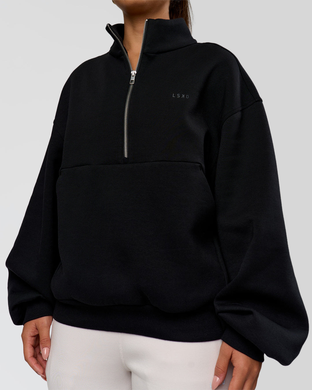 Woman wearing Luxe ZeroCrease Spacer Half Zip - Black | Model:Sophia | Size:XS - view 7