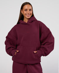 Woman wearing MVP Oversized Hoodie - Cherry Lacquer | Model:Brylee | Size:XS | Thumbnail Index: 1