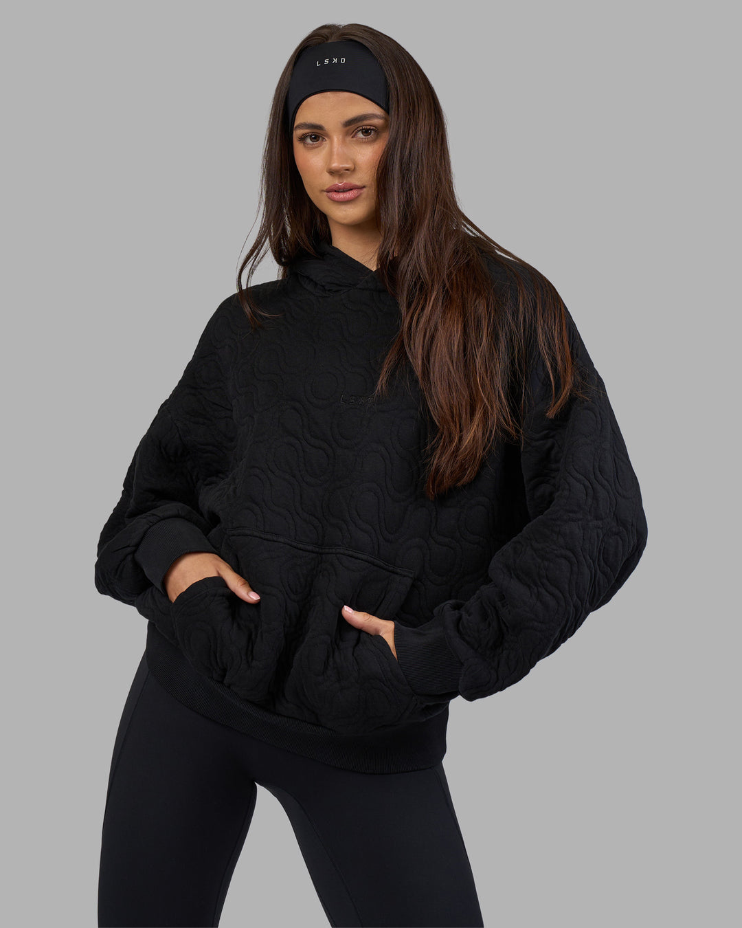 Woman wearing MVP Quilted Oversized Hoodie - Black-Geometric | Model:Phoebe | Size:XS - view 2