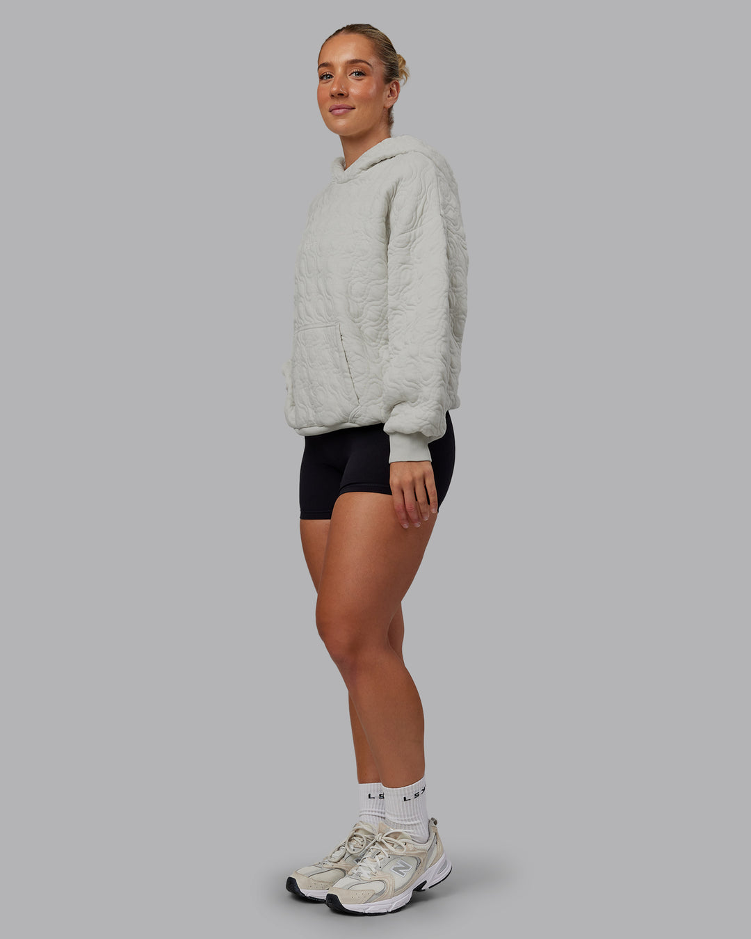 Woman wearing MVP Quilted Oversized Hoodie - Digital Mist-Geometric | Model:Lyss | Size:XS - view 10