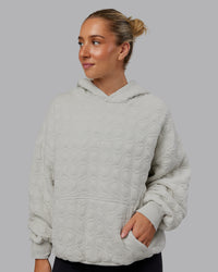 Woman wearing MVP Quilted Oversized Hoodie - Digital Mist-Geometric | Model:Lyss | Size:XS | Thumbnail Index: 2