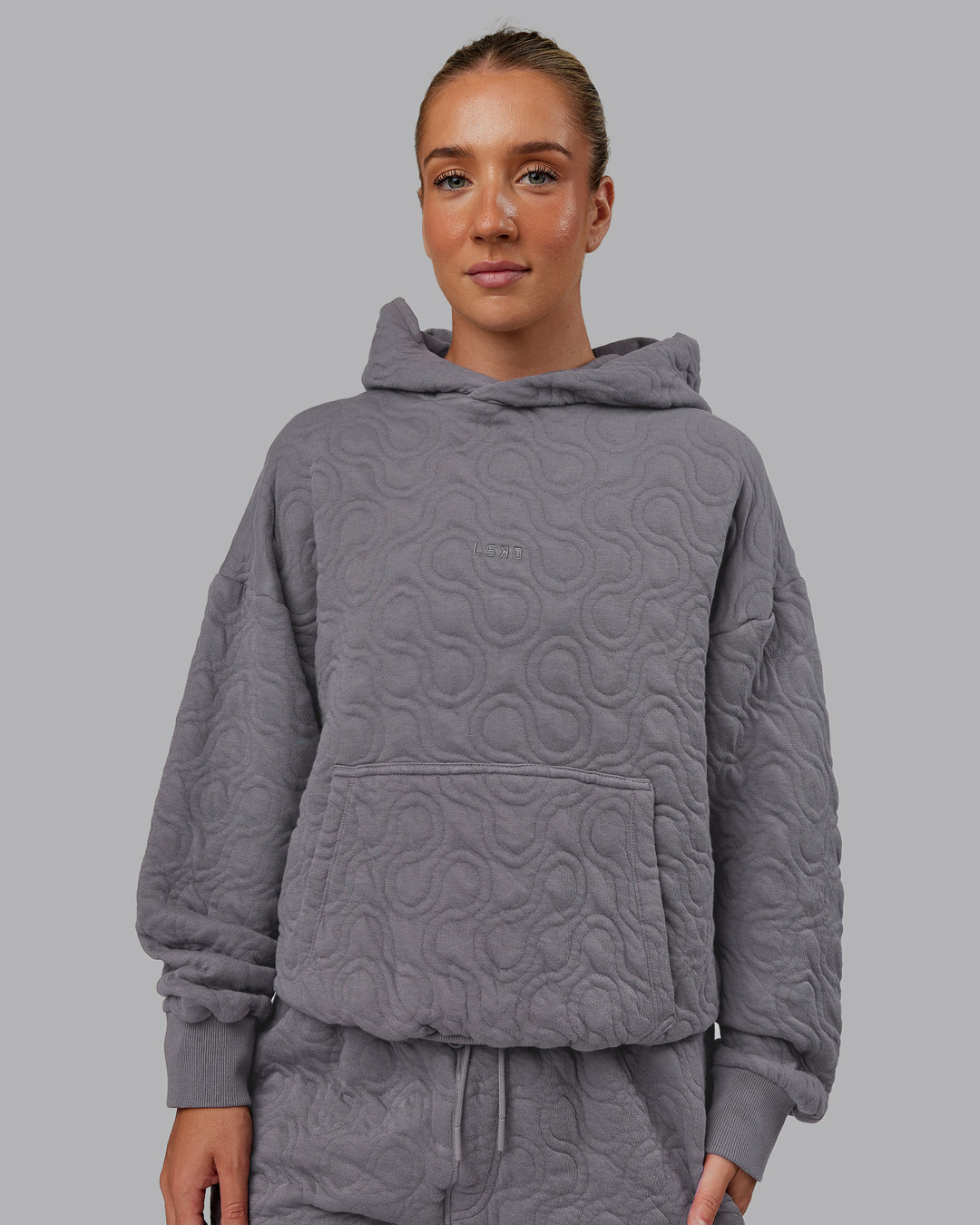 Woman wearing MVP Quilted Oversized Hoodie - Storm Front-Geometric | Model:Lyss | Size:XS - view 5