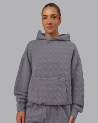 Woman wearing MVP Quilted Oversized Hoodie - Storm Front-Geometric | Model:Lyss | Size:XS | Thumbnail Index: 4