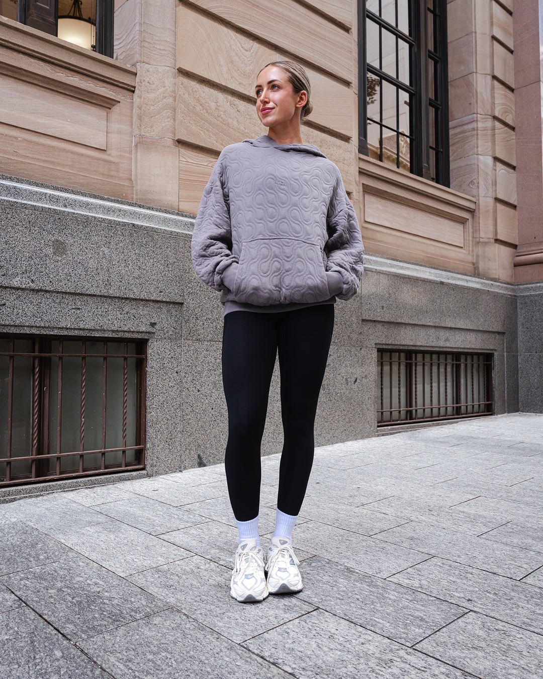 Woman wearing MVP Quilted Oversized Hoodie - Storm Front-Geometric | Model:Paris | Size:XS - view 2