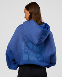Woman wearing Memory In Motion Ultra Heavyweight Washed Hoodie - Electric Indigo Washed | Model:Brylee | Size:XS | Thumbnail Index: 3