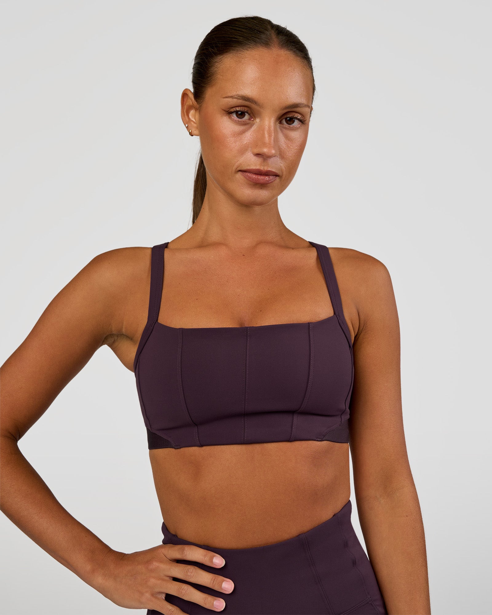 Woman wearing Momentum Corset Sports Bra - Midnight Plum | Model:Brylee | Size:XS