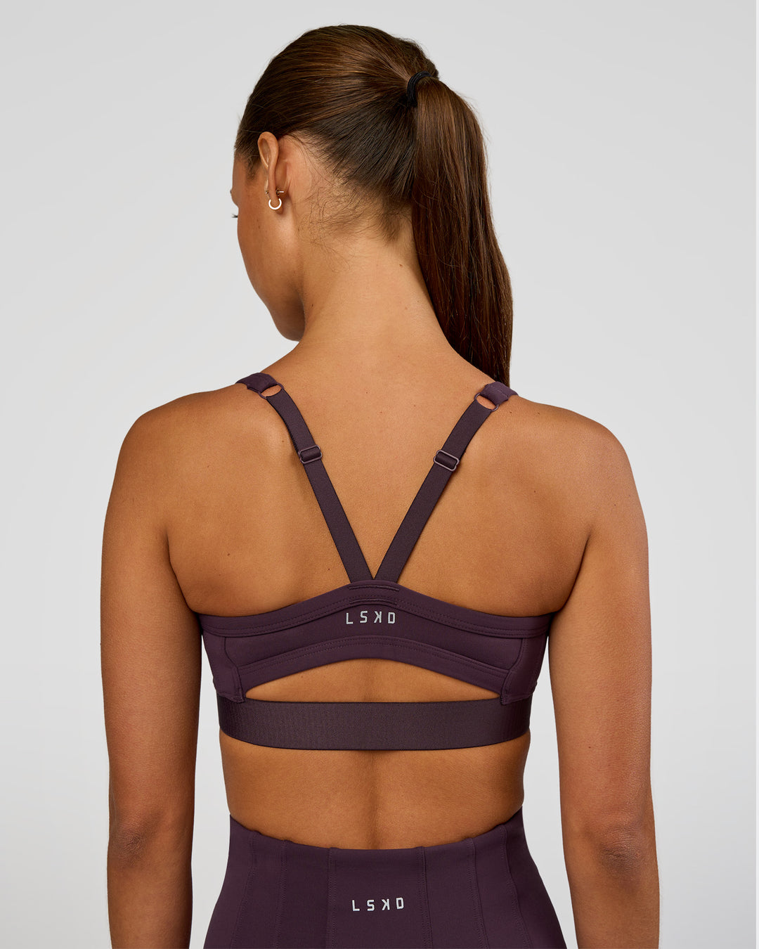 Woman wearing Momentum Corset Sports Bra - Midnight Plum | Model:Brylee | Size:XS - view 3
