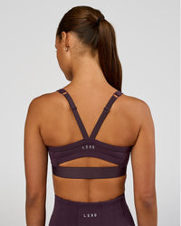 Woman wearing Momentum Corset Sports Bra - Midnight Plum | Model:Brylee | Size:XS | Thumbnail Index: 2