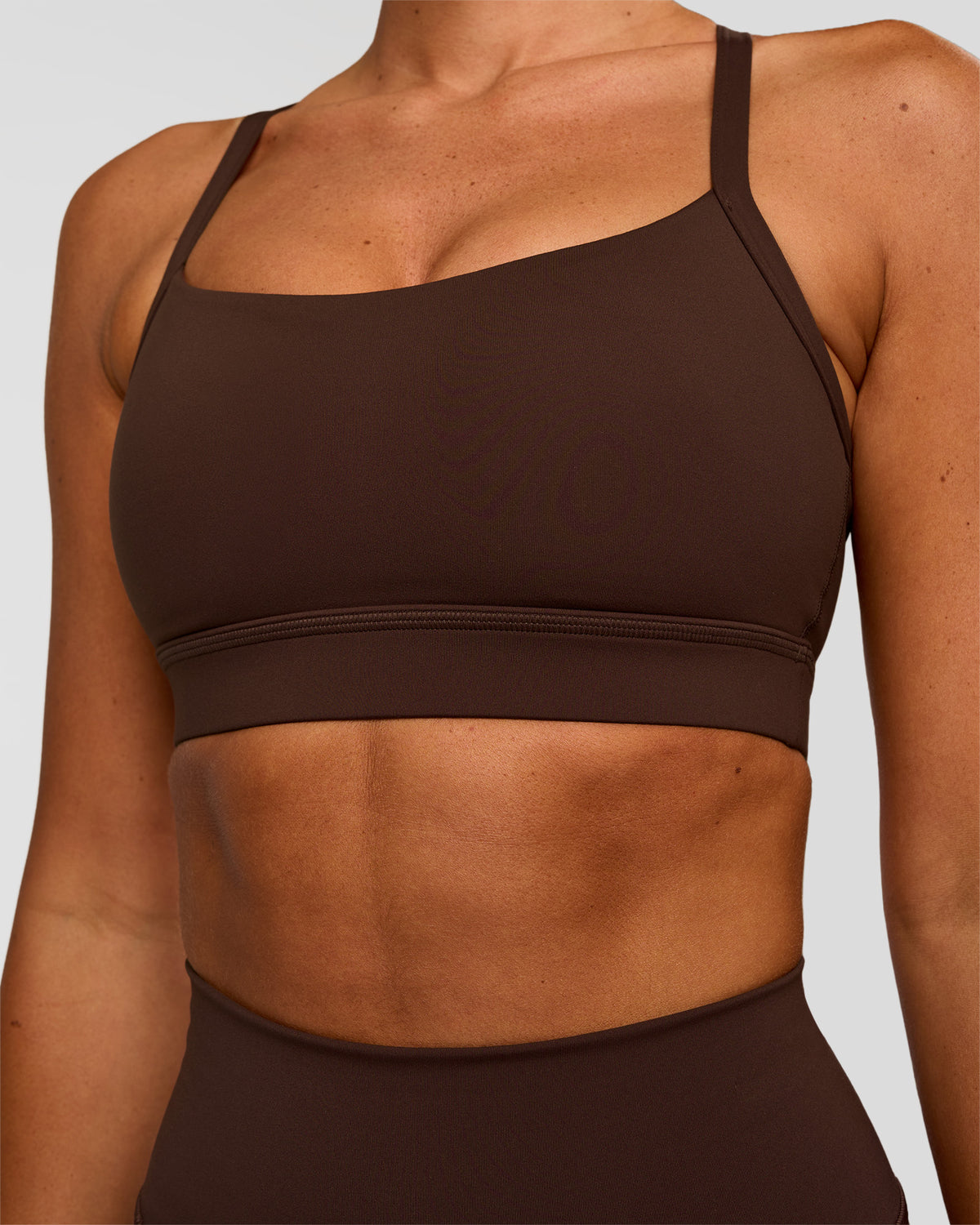 Woman wearing Momentum Sports Bra - Hot Chocolate | Model:Charli | Size:XS - view 1