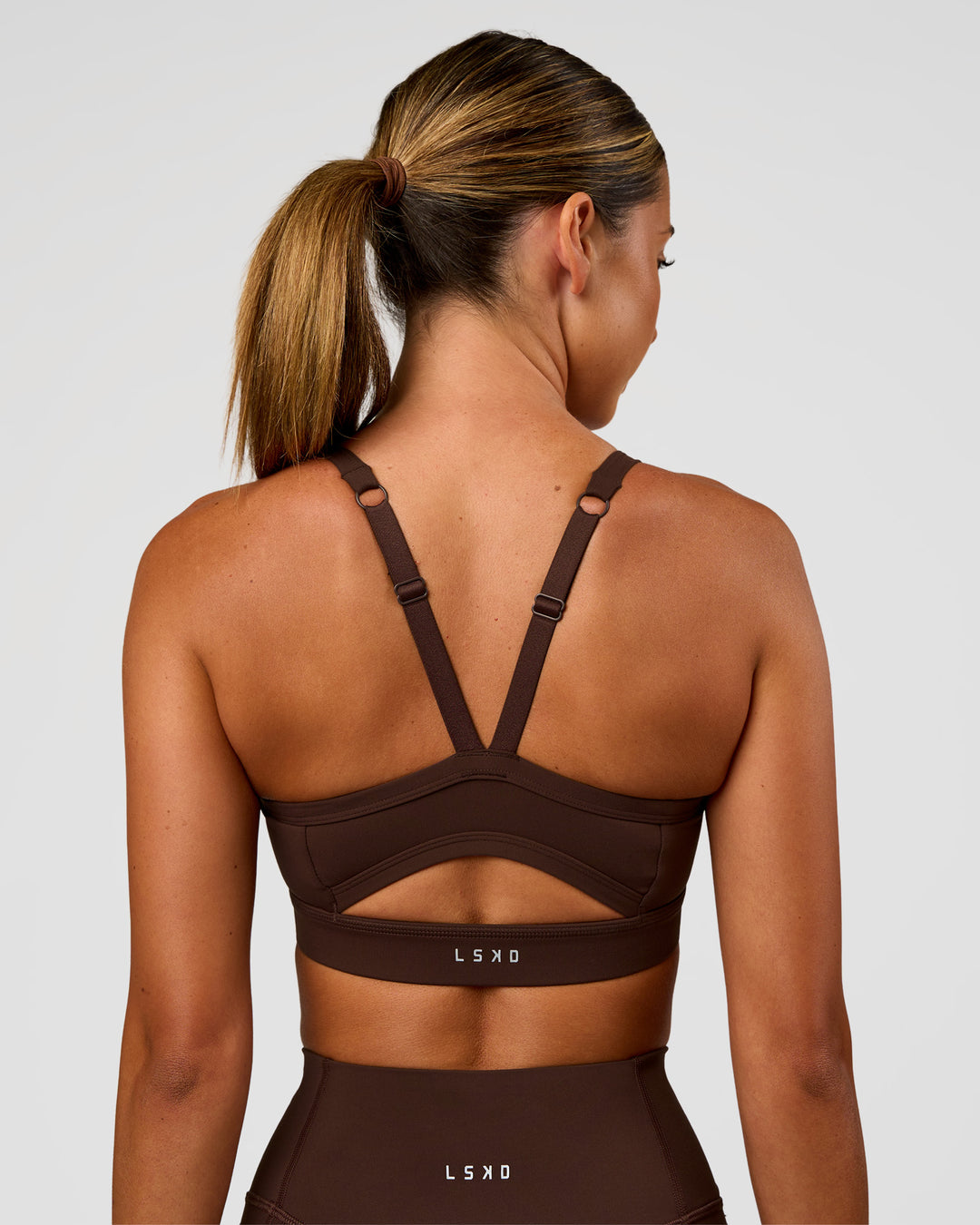 Woman wearing Momentum Sports Bra - Hot Chocolate | Model:Charli | Size:XS - view 5