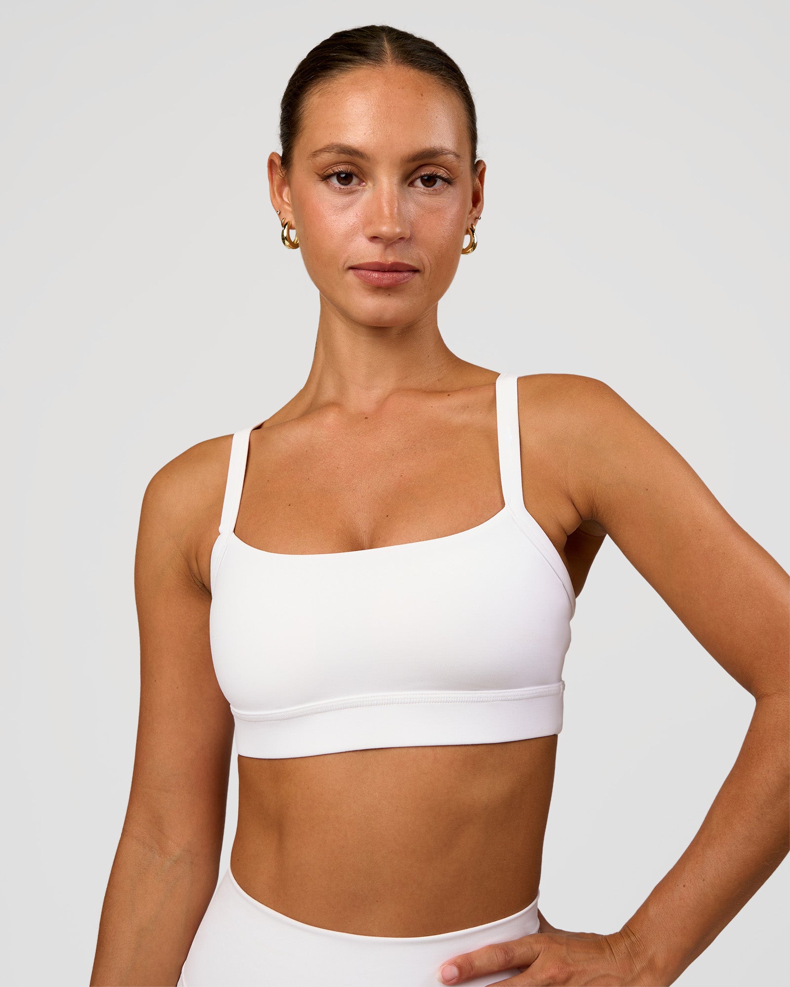 Woman wearing Momentum Sports Bra - White | Model:Brylee | Size:XS