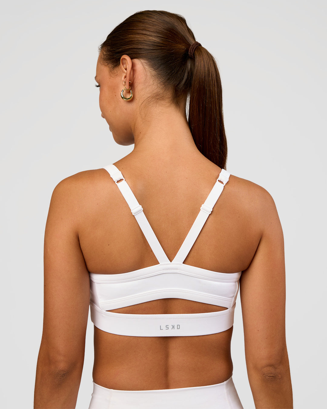 Woman wearing Momentum Sports Bra - White | Model:Brylee | Size:XS - view 5