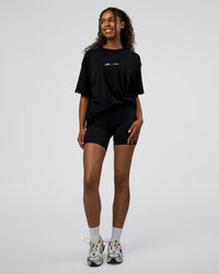 Woman wearing Movember 2025 FLXCotton Oversize Tee - Black | Model:Jordan | Size:XS | Thumbnail Index: 9