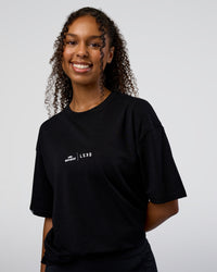 Woman wearing Movember 2025 FLXCotton Oversize Tee - Black | Model:Jordan | Size:XS | Thumbnail Index: 4