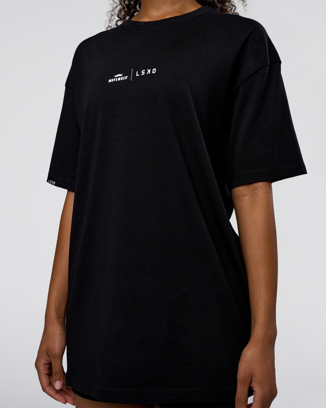 Woman wearing Movember 2025 FLXCotton Oversize Tee - Black | Model:Jordan | Size:XS - view 11