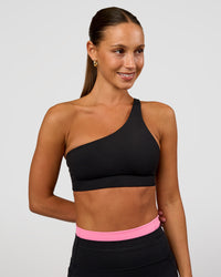 Woman wearing Muse Asymmetric Sports bra - Black | Model:Brylee | Size:XS | Thumbnail Index: 7
