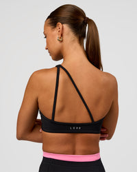 Woman wearing Muse Asymmetric Sports bra - Black | Model:Brylee | Size:XS | Thumbnail Index: 8