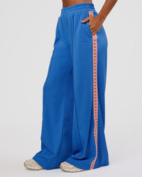 Woman wearing Peaches Track Pant - Palace Blue | Model:Brylee | Size:XS | Thumbnail Index: 0