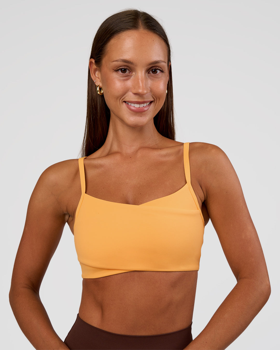 Woman wearing Peaches Wrap Sports Bra - Warm Apricot | Model:Brylee | Size:XS - view 3