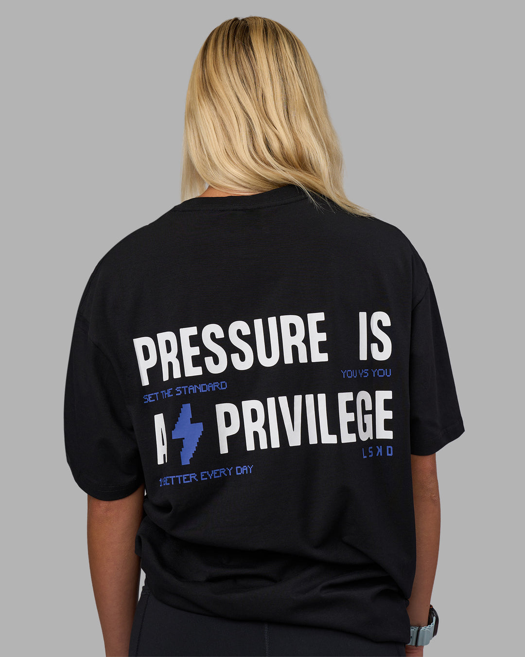 Woman wearing Pressure is a Privilege FLXCotton Oversized Tee - Black-Power Cobalt | Model:Alex | Size:XS - view 2
