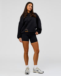 Woman wearing Pride Sticker Boxy Hoodie - Black | Model:Bianca | Size:XS | Thumbnail Index: 19