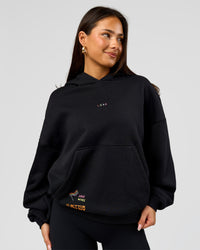 Woman wearing Pride Sticker Boxy Hoodie - Black | Model:Bianca | Size:XS | Thumbnail Index: 8