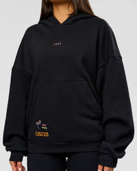 Woman wearing Pride Sticker Boxy Hoodie - Black | Model:Bianca | Size:XS | Thumbnail Index: 16