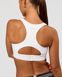 Woman wearing Race Day Sports Bra - White | Model:Brylee | Size:XS | Thumbnail Index: 1