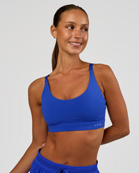 Woman wearing Rapid Sports Bra - Electric Indigo | Model:Brylee | Size:XS | Thumbnail Index: 0