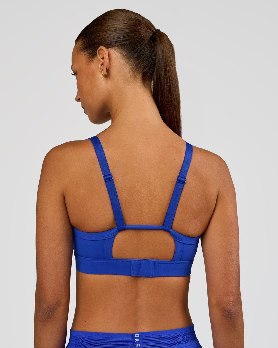 Woman wearing Rapid Sports Bra - Electric Indigo | Model:Brylee | Size:XS - view 2
