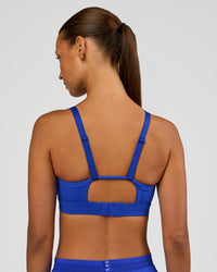 Woman wearing Rapid Sports Bra - Electric Indigo | Model:Brylee | Size:XS | Thumbnail Index: 1