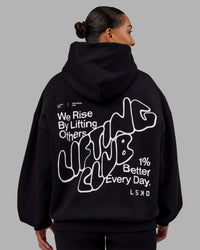 Woman wearing Rise & Lift Hoodie Oversized - Black-White | Model:Ayla | Size:XS | Thumbnail Index: 1