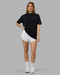 Woman wearing RUN CLUB FLXCotton Tee Oversize - Black-Reflective | Model:Emilie | Size:XS | Thumbnail Index: 5