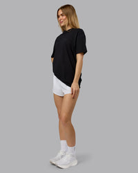 Woman wearing RUN CLUB FLXCotton Tee Oversize - Black-Reflective | Model:Emilie | Size:XS | Thumbnail Index: 8