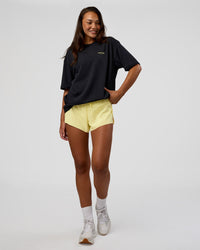 Woman wearing RUN CLUB FLXCotton Tee Oversize - Black-Yellow Fizz | Model:Kirstyn | Size:XS | Thumbnail Index: 7
