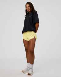 Woman wearing RUN CLUB FLXCotton Tee Oversize - Black-Yellow Fizz | Model:Kirstyn | Size:XS | Thumbnail Index: 10