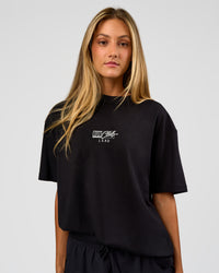 Woman wearing Run Club Script FLXCotton Oversized Tee - Black-Alloy | Model:Georgia | Size:XS | Thumbnail Index: 3