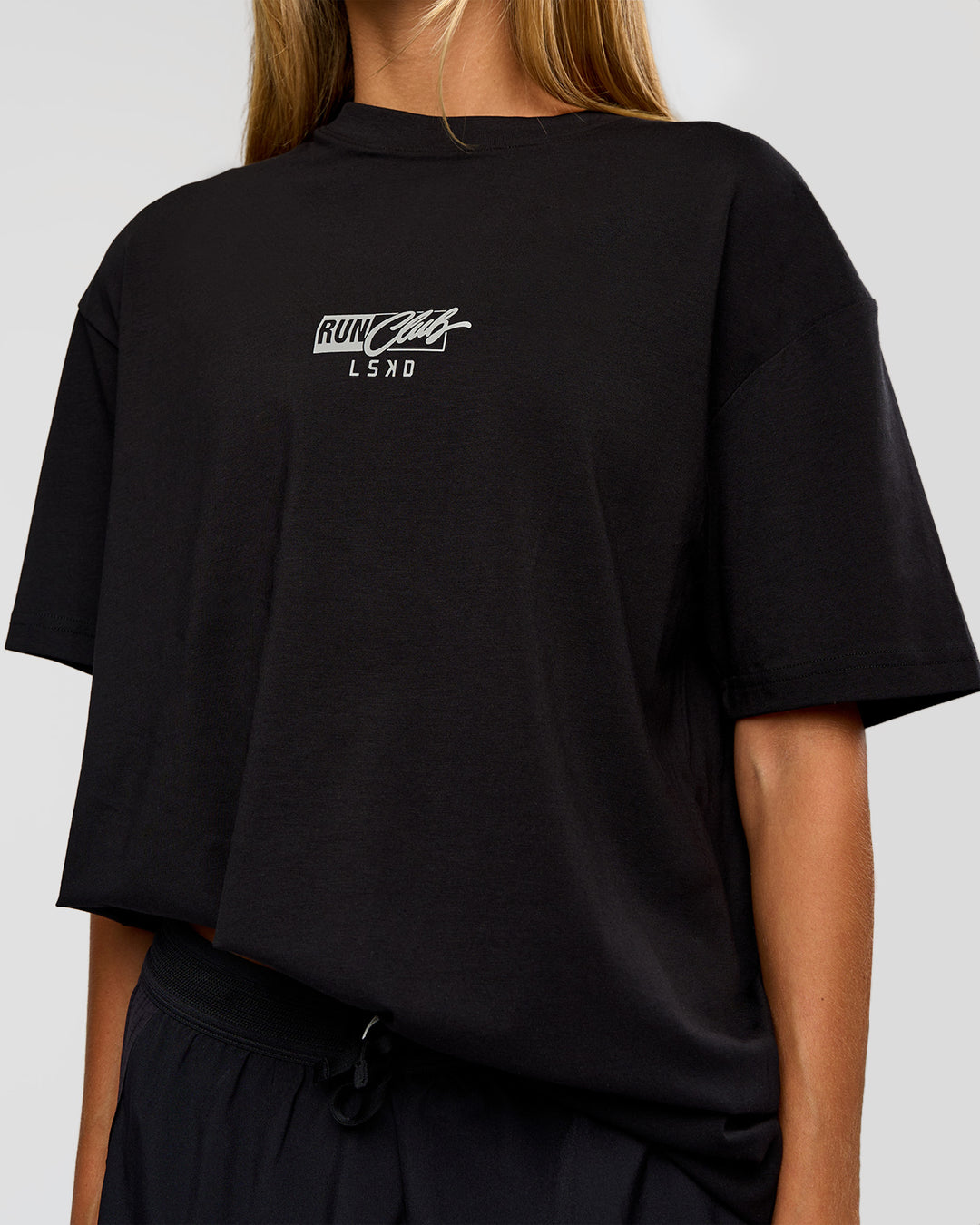 Woman wearing Run Club Script FLXCotton Oversized Tee - Black-Alloy | Model:Georgia | Size:XS - view 10