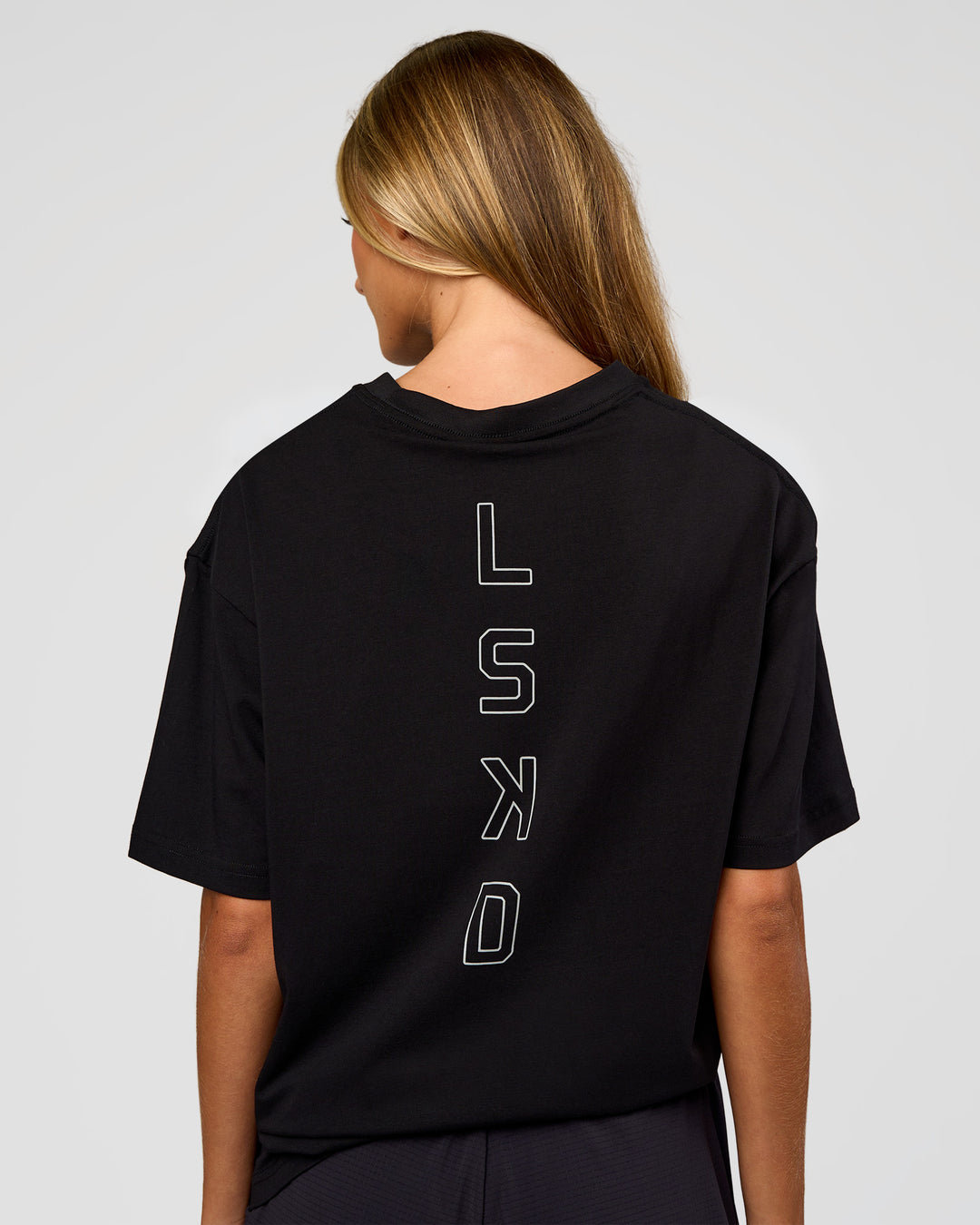 Woman wearing Run Club Script FLXCotton Oversized Tee - Black-Alloy | Model:Georgia | Size:XS - view 5