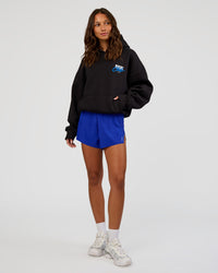 Woman wearing Run Club Script Oversized Hoodie - Black-Palace Blue | Model:Dakota | Size:XS | Thumbnail Index: 7