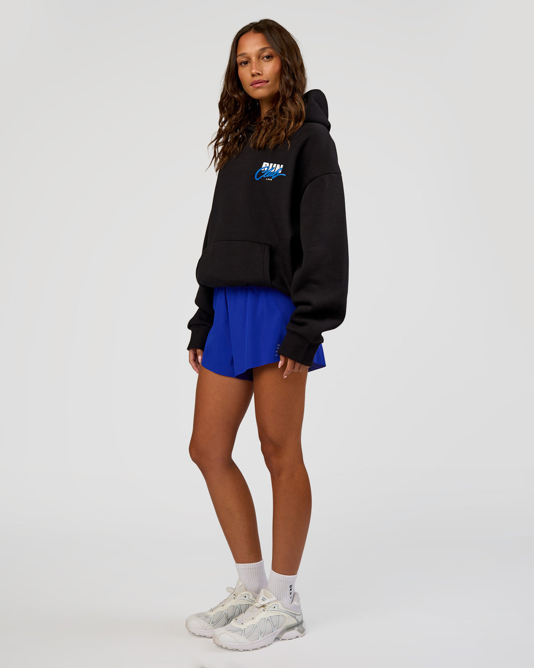 Woman wearing Run Club Script Oversized Hoodie - Black-Palace Blue | Model:Dakota | Size:XS - view 13